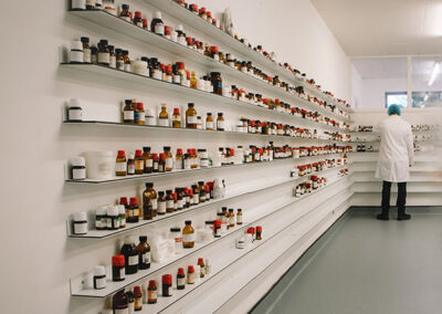 Lab wall of shelves with sample bottles