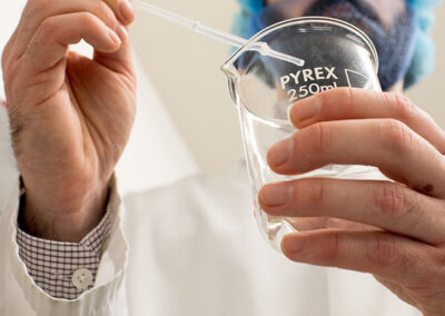 Specialist using a pipette in a beaker